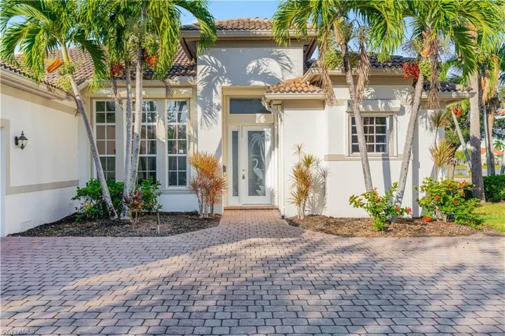 Entrance to property featuring stucco siding and a tile roof