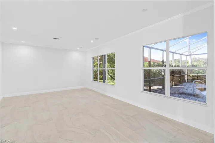 Empty room with ornamental molding and recessed lighting