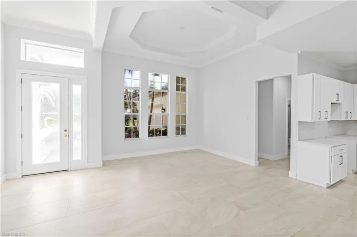 Entryway featuring crown molding and baseboards