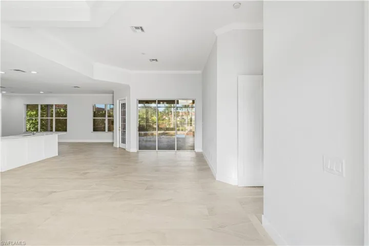 Empty room featuring healthy amount of natural light and crown molding