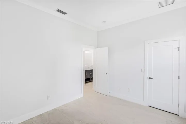 Unfurnished bedroom with ornamental molding and baseboards