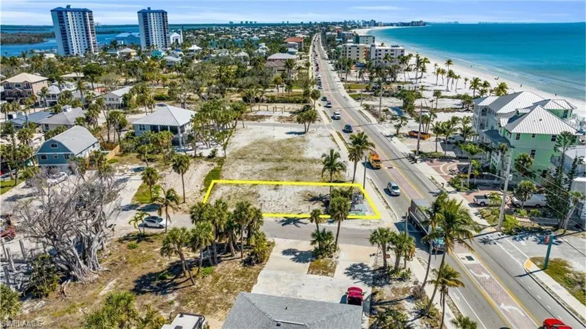 Aerial perspective of suburban area featuring unending shoreline and property parcel outlined - VIRTUALLY EDITED