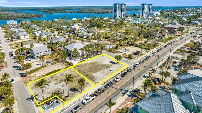 Generously sized lot 100 x 100 +/-offers unparalleled proximity to the white sands and turquoise waters of Fort Myers Beach - Virtually Edited Image