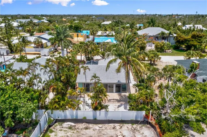 View of the back yard and wall of windows  - Sanibel is coming back to life - come live your best life on the island!