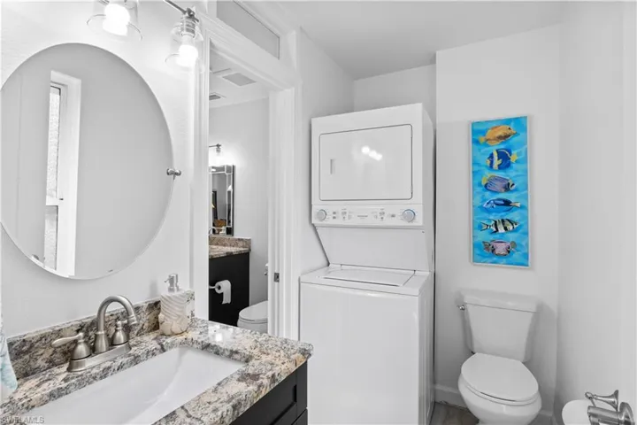 Second bathroom with washer and dryer stackable access.