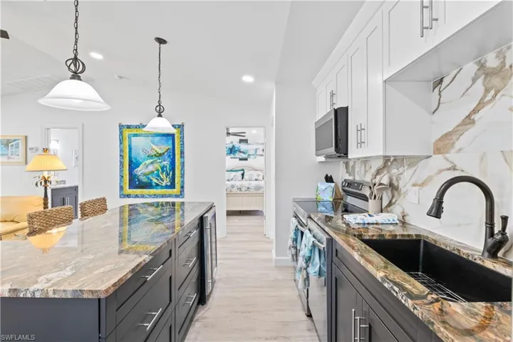 Close up of the luxury countertops and backsplash!  Beverage bar is perfect for wine and this is the perfect layout for entertaining!
