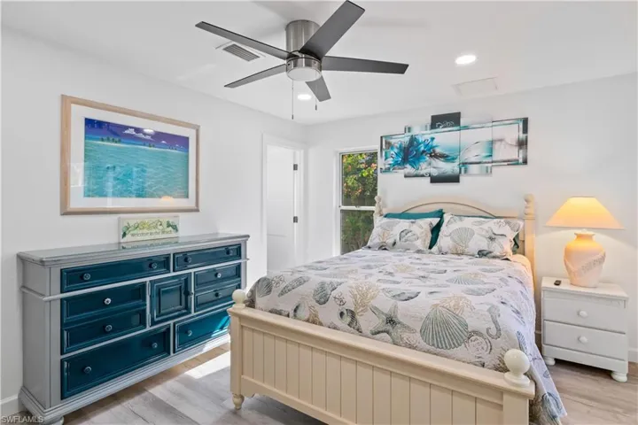 Generous size guest bedroom with new flooring, baseboards, lighting, paint and ceiling fan!