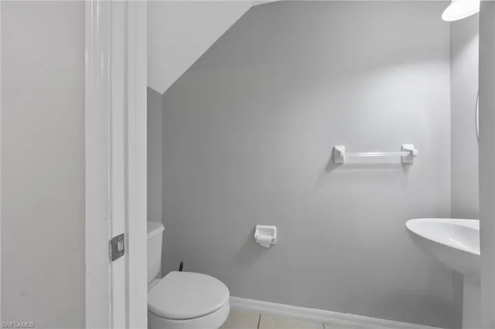 Bathroom featuring lofted ceiling and tile patterned flooring
