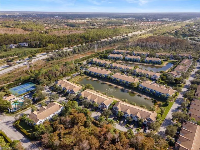 Aerial view of property's location featuring a large body of water and nearby suburban area