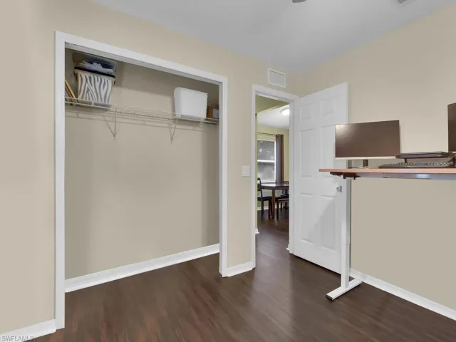 Unfurnished bedroom with a closet and dark hardwood / wood-style floors