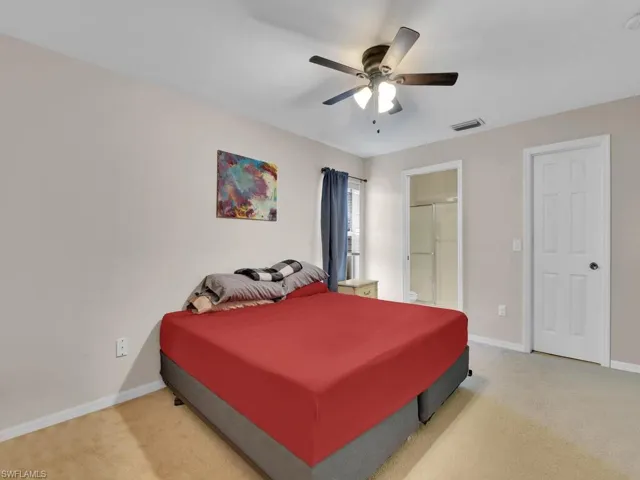 Bedroom featuring ceiling fan and carpet floors