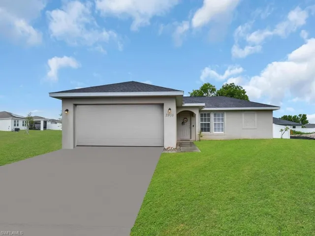Single story home featuring a garage and a front yard