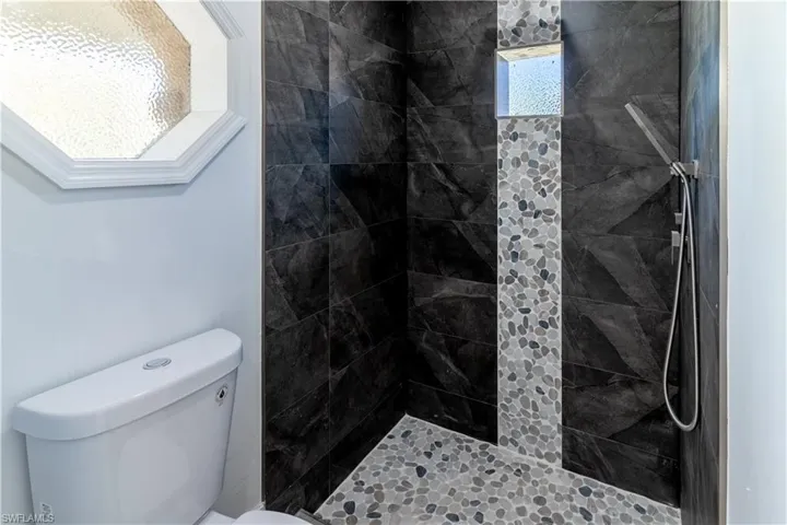 Full bathroom with a stall shower