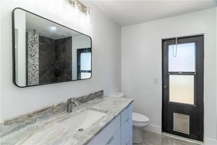 Bathroom featuring vanity and a tile shower