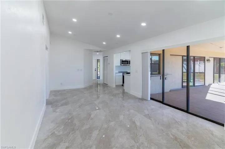 Spare room featuring recessed lighting and lofted ceiling