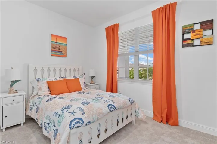 Bedroom with light carpet and baseboards