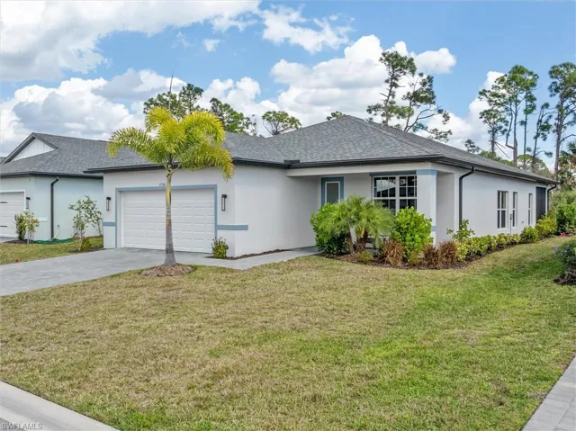 Ranch-style home with stucco siding and a front yard