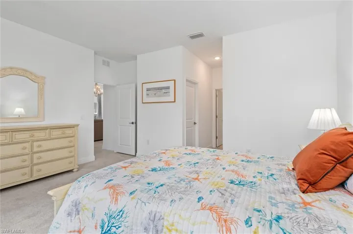 Bedroom featuring light carpet and baseboards