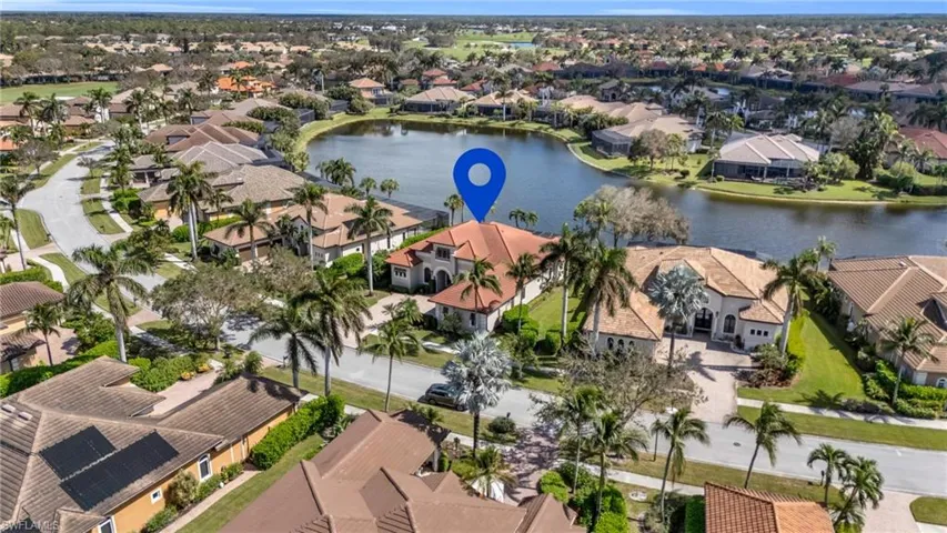 Birds eye view of property with a water view