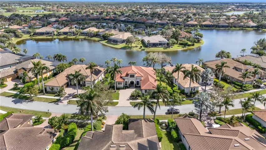 Birds eye view of property with a water view