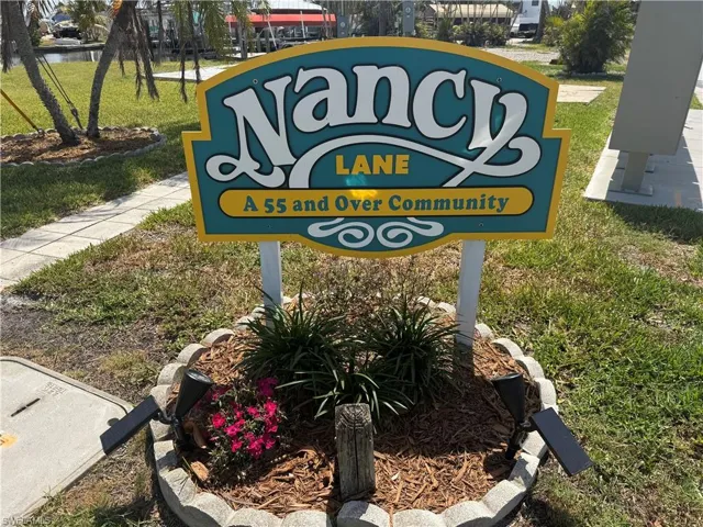 Community / neighborhood sign with a yard