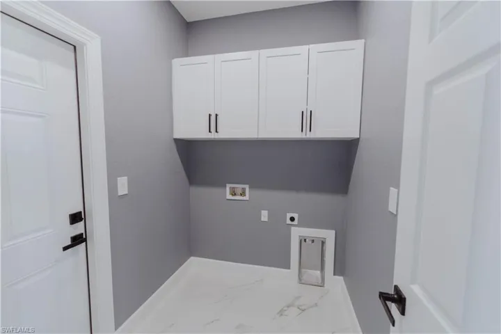 Laundry area with cabinets, electric dryer hookup, and washer hookup