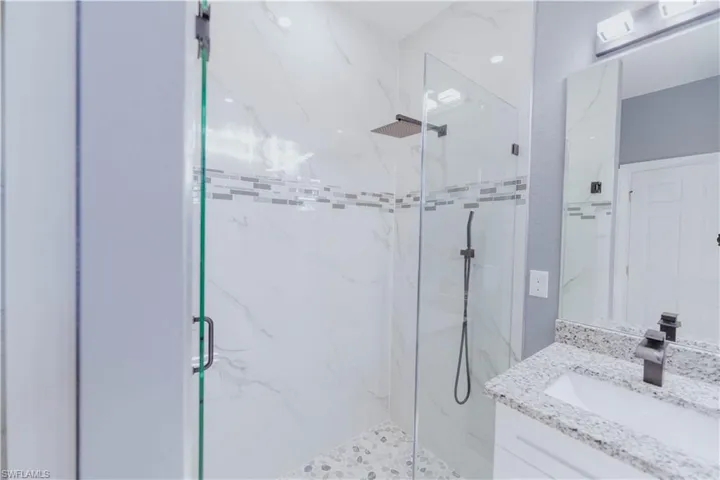 Bathroom featuring vanity and an enclosed shower