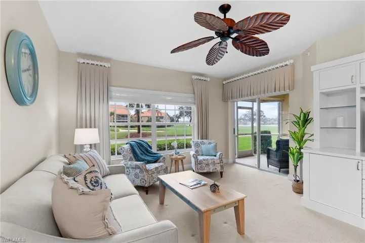 Living room featuring light carpet and ceiling fan