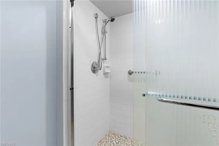 Bathroom with a shower with door