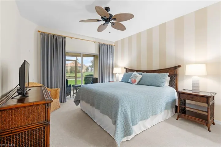 Bedroom featuring access to exterior, light carpet, and ceiling fan