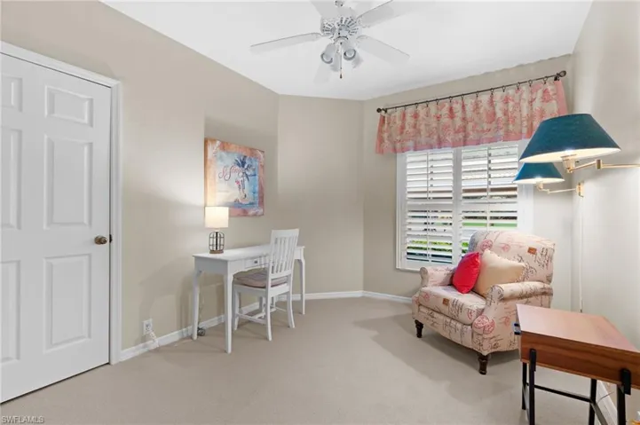 Carpeted office space with ceiling fan