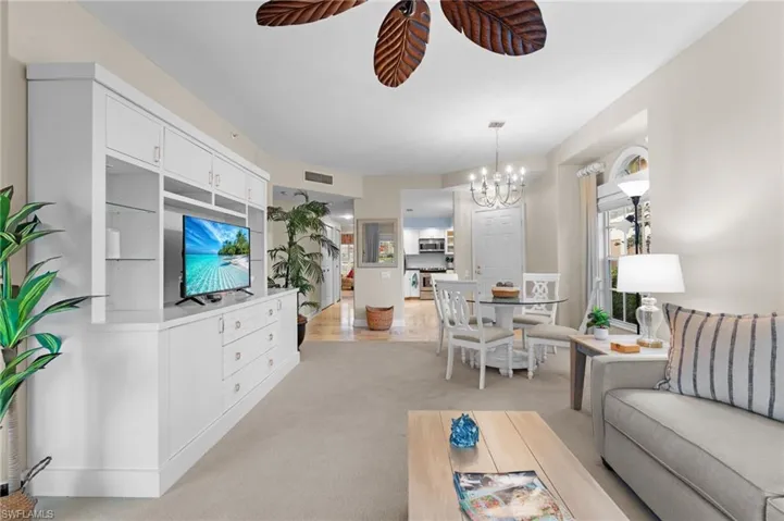 Carpeted living room featuring a chandelier