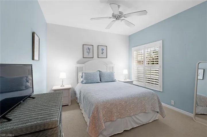 Bedroom with light carpet and ceiling fan