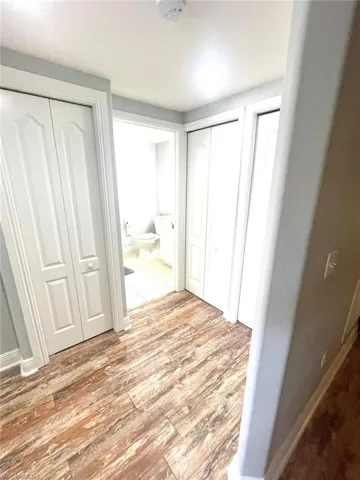 Unfurnished bedroom with two closets and light wood-type flooring
