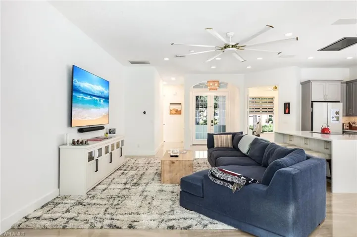 Open-concept living space featuring light wood-finish flooring and recessed lighting
