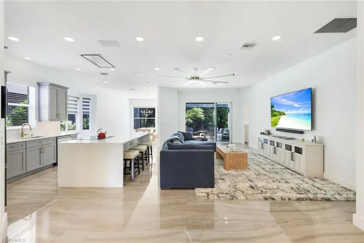 Open-concept living area with polished tile flooring throughout