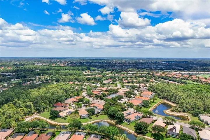 Expansive residential area featuring numerous homes with varied rooflines and surrounding mature trees