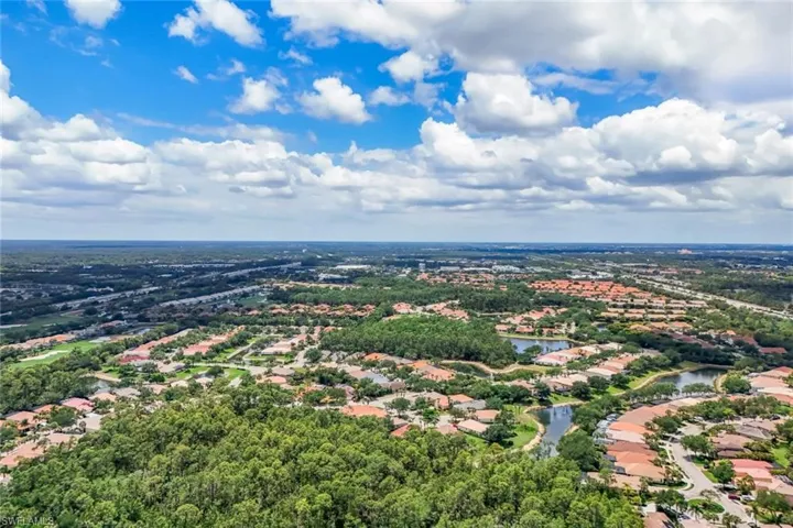Expansive aerial perspective showcasing a residential community with abundant green spaces