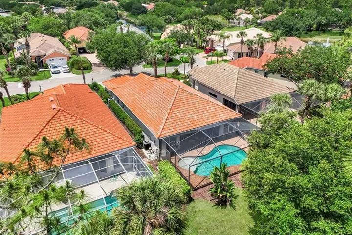 Aerial perspective highlighting a residential property with a screened-in pool