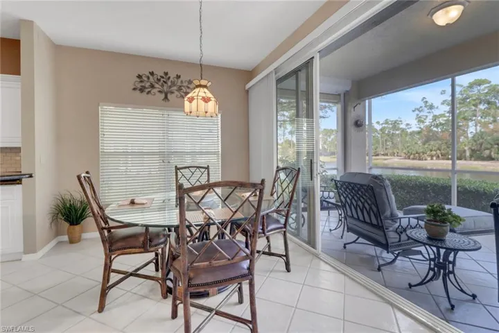 Dining area with light tile patterned flooring