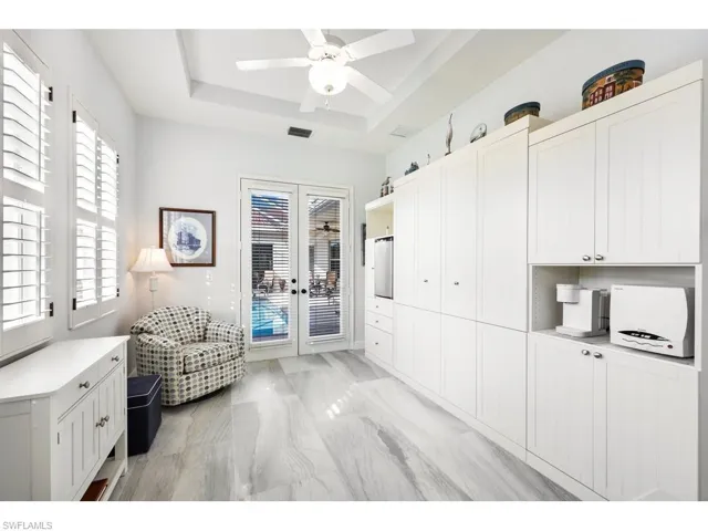 3rd bedroom doubles as a Sitting room featuring french doors to the pool, coffee bar, small frig and room for a small microwave