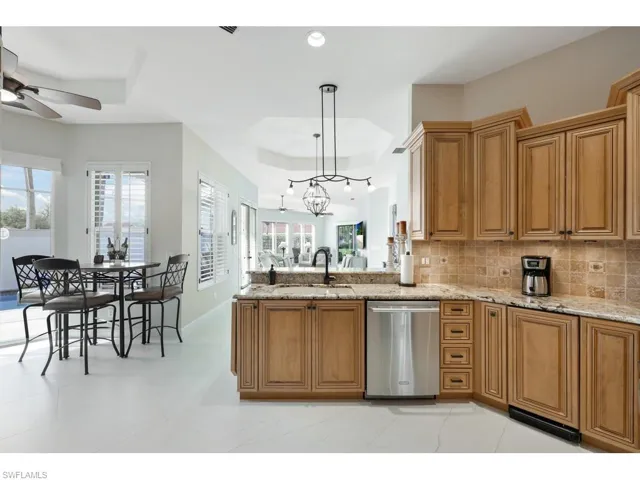 Kitchen with stainless steel dishwasher, plenty of natural light, and backsplash
