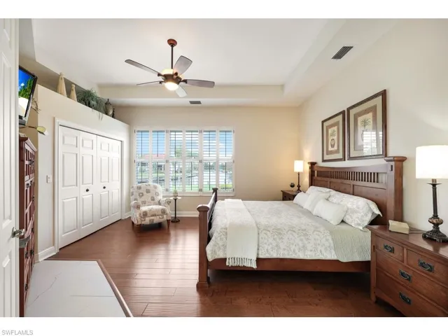 Bedroom featuring a closet, dark hardwood / wood-style floors, and ceiling fan