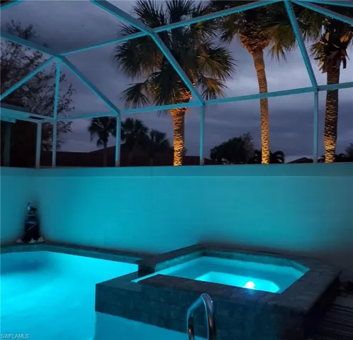 Pool at dusk with an in ground hot tub enjoy a relaxing evening.