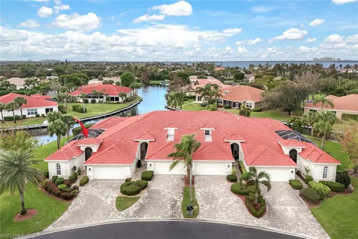 Birds eye view of property with a water view