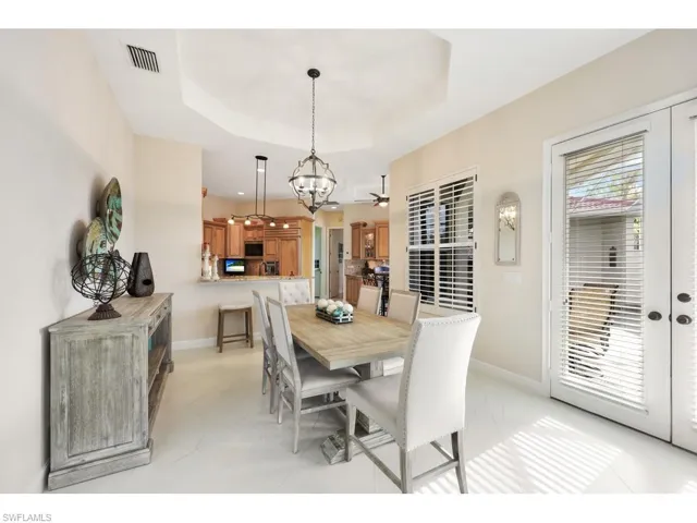 Tiled dining space with French doors to entertain by the pool