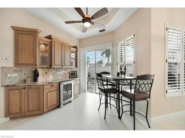 Butler's pantry with wine cooler, wine racks and extra countertop
