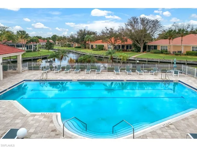Community pool with tables and community room with kitchen and workout area