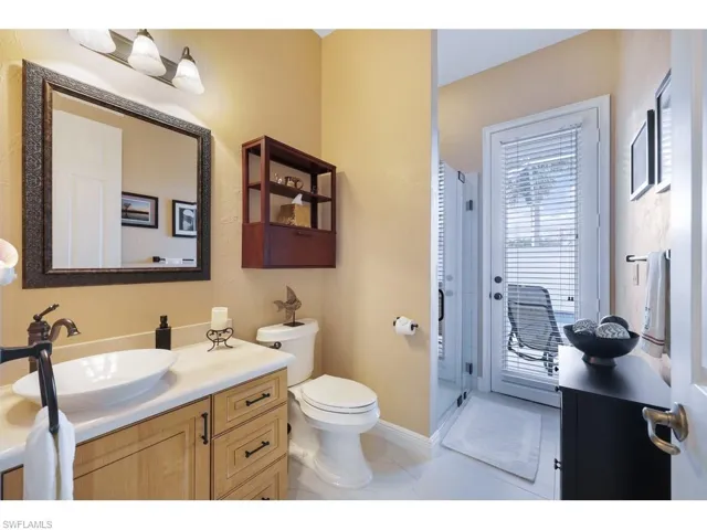 Bathroom featuring vanity, walk in shower, and tile floors, recently updated, pool access