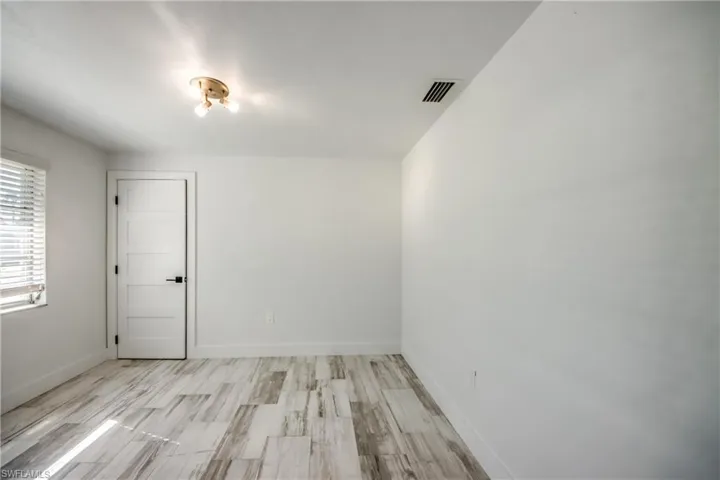 Bathroom featuring a shower stall, vanity, recessed lighting, and tile patterned flooring